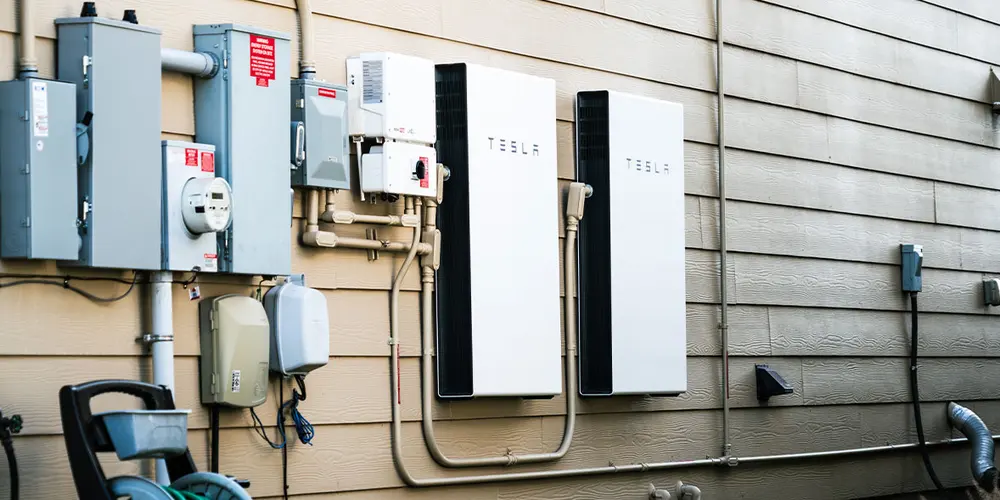 Battery storage system installed on a home exterior wall
